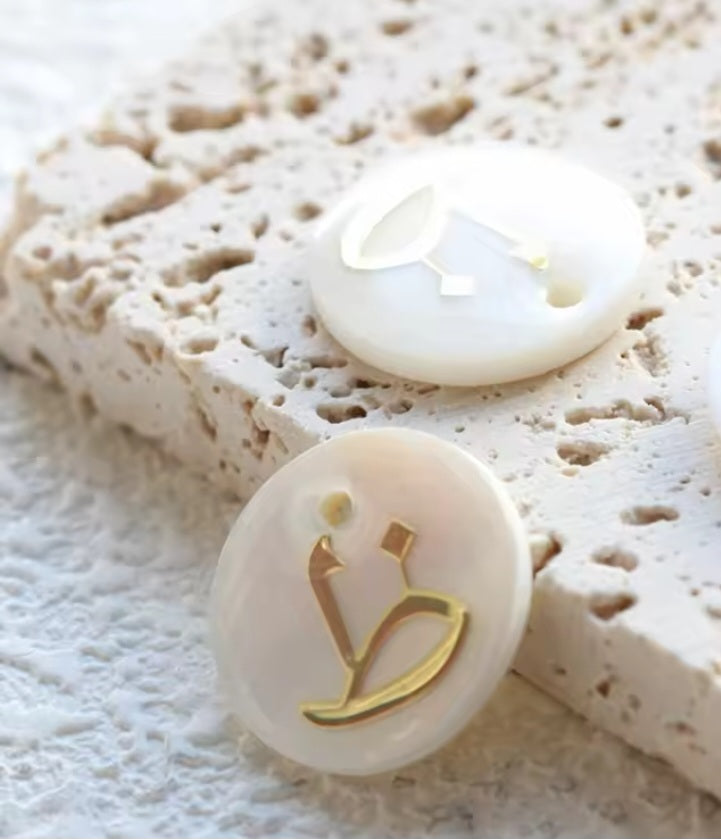 Arabic letters charm on shells